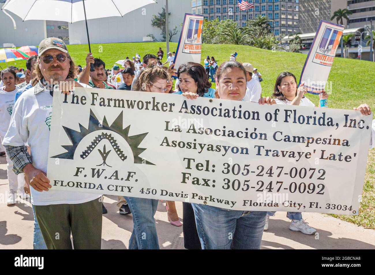 Miami Florida,Bayfront Park,immigrants rights protest,Hispanic men women carrying holding banner Farmworker Association Stock Photo