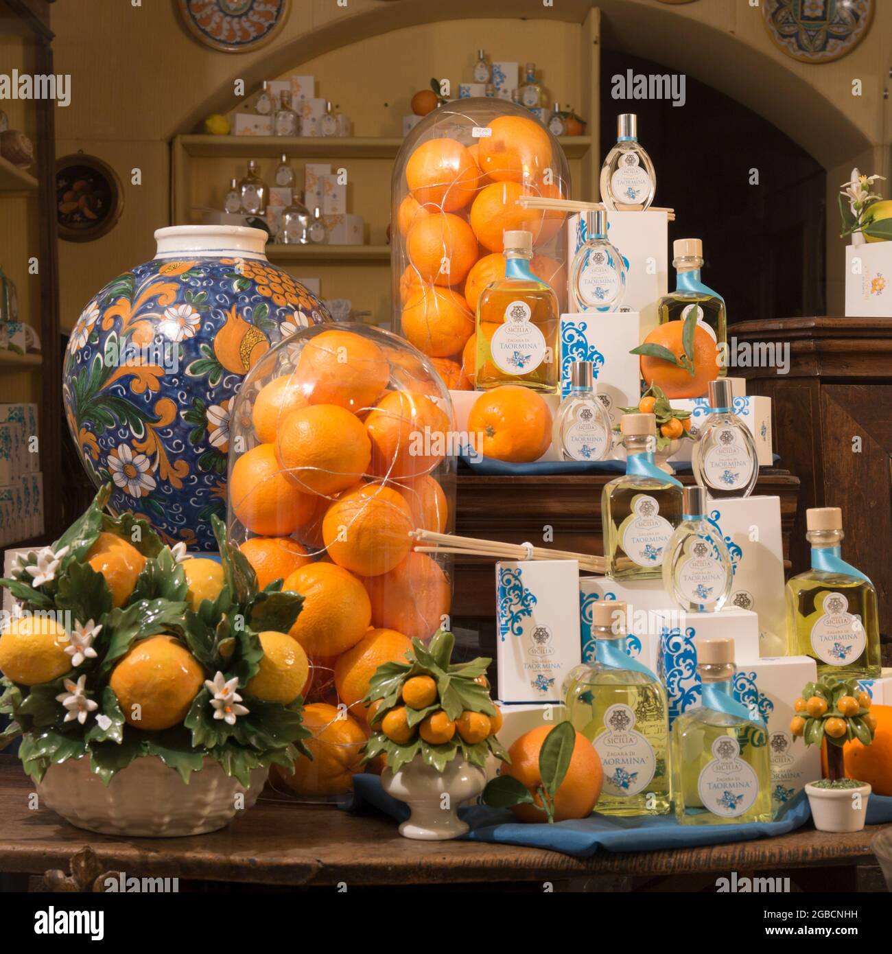 Taormina, Messina, Sicily, Italy. Traditional perfume shop window display featuring jars of oranges, traditional ceramics and island fragrances. Stock Photo