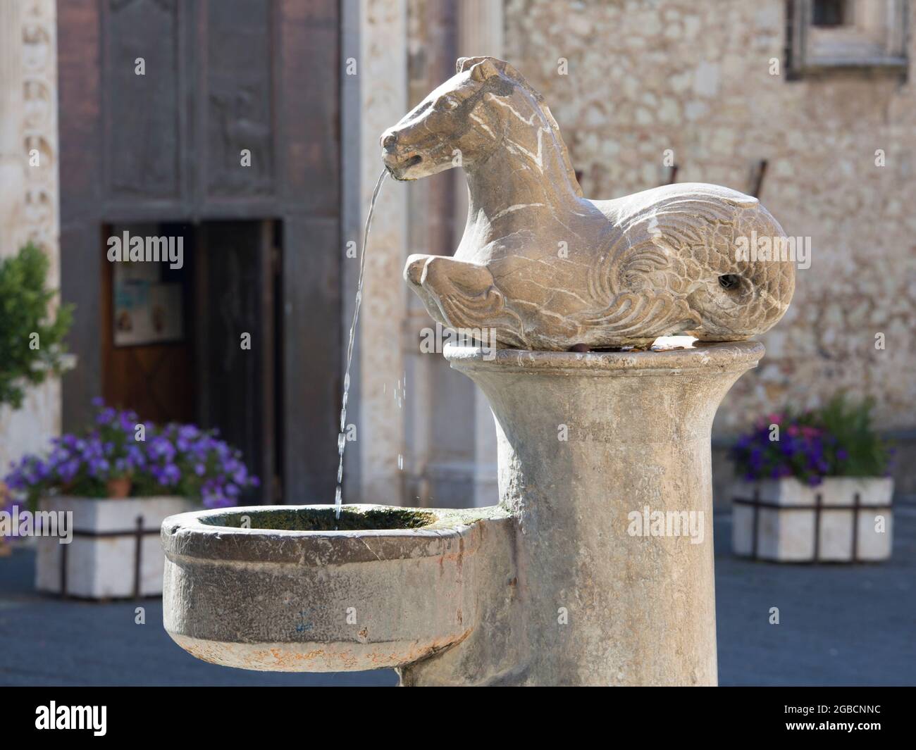 Taormina, Messina, Sicily, Italy. Water spouting from seahorse, part of a baroque fountain in front of the Cathedral of San Nicolò, Piazza del Duomo. Stock Photo
