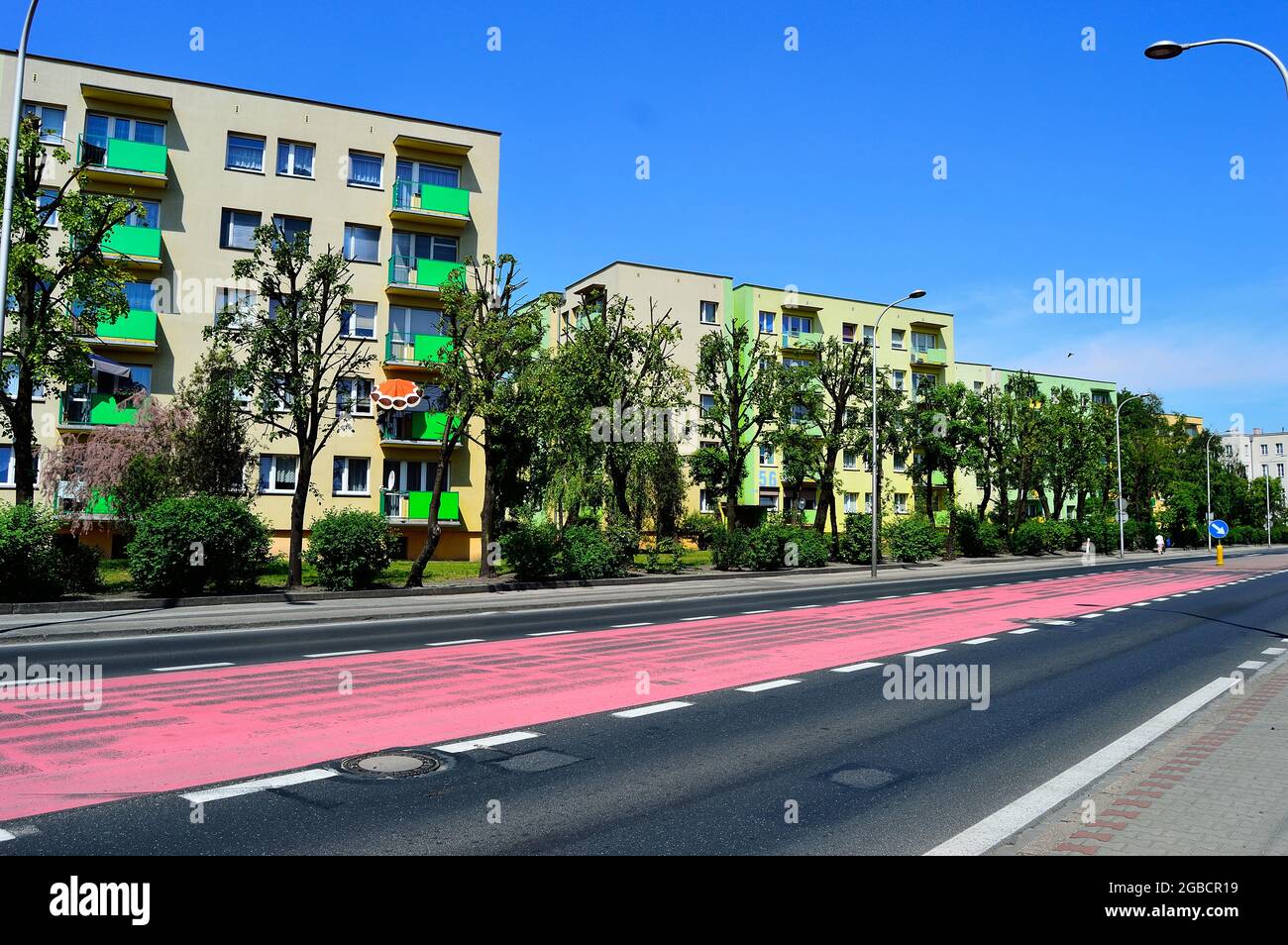 Multi-family houses on a street among trees. Summer. Stock Photo