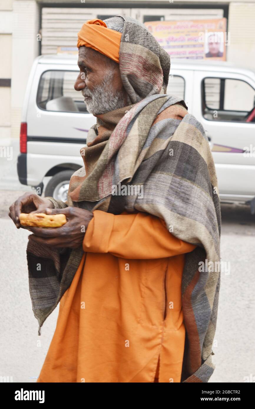 Rishikesh, Uttarakhand, India - May 06, 2018: Indian Monk Eating Food, Rishikesh,India. Stock Photo