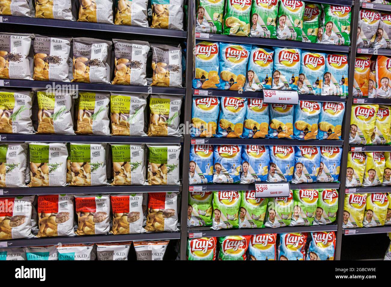 Johannesburg South Africa,Rosebank The Zone Mall Woolworths,grocery store supermarket store interior inside shelves,display sale bags potato chips cri Stock Photo