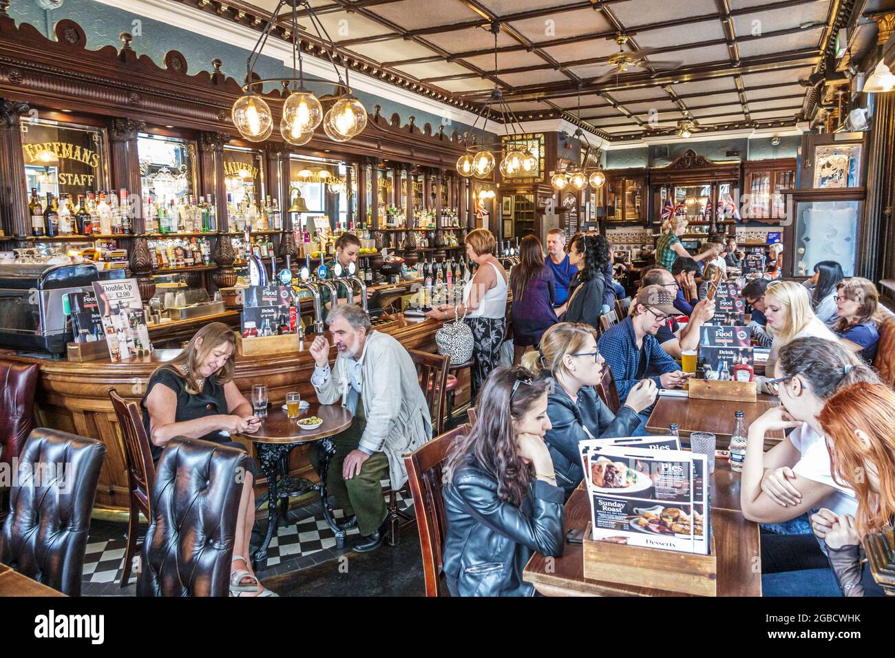 London England,UK Bloomsbury,Museum Tavern Grade II historic public house,restaurant bar pub couples men women inside interior Stock Photo