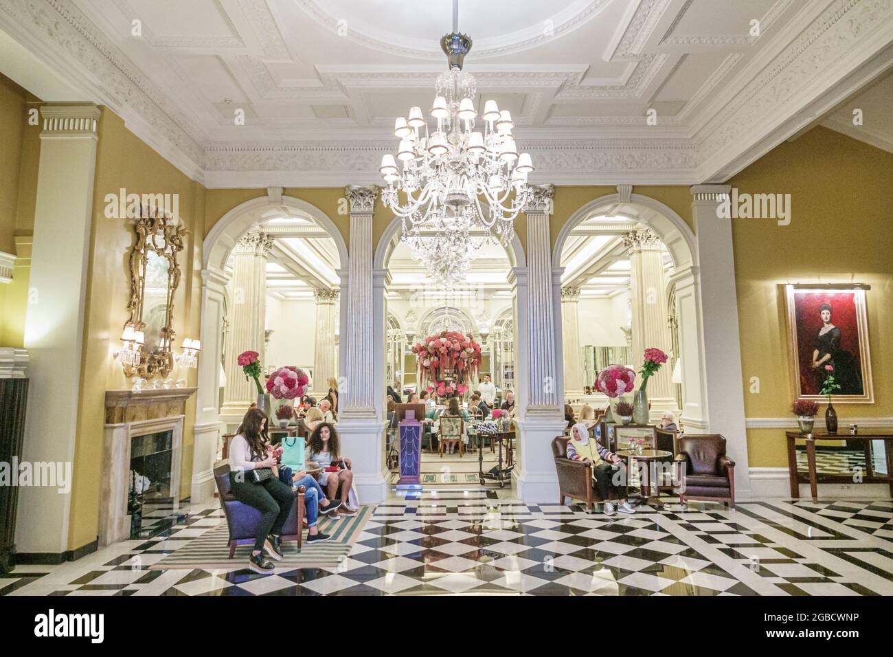 London England,UK,Mayfair Claridge's hotel 5-star luxury historic building,inside interior lobby chandelier Black white checkerboard marble floor, Stock Photo