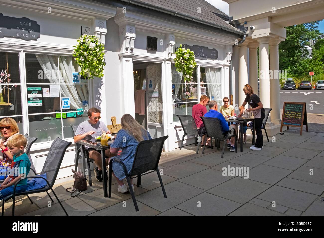 People social distancing during covid sitting at tables outside The Duchess Restaurant in Brecon town centre summer 2021 Powys Wales UK  KATHY DEWITT Stock Photo