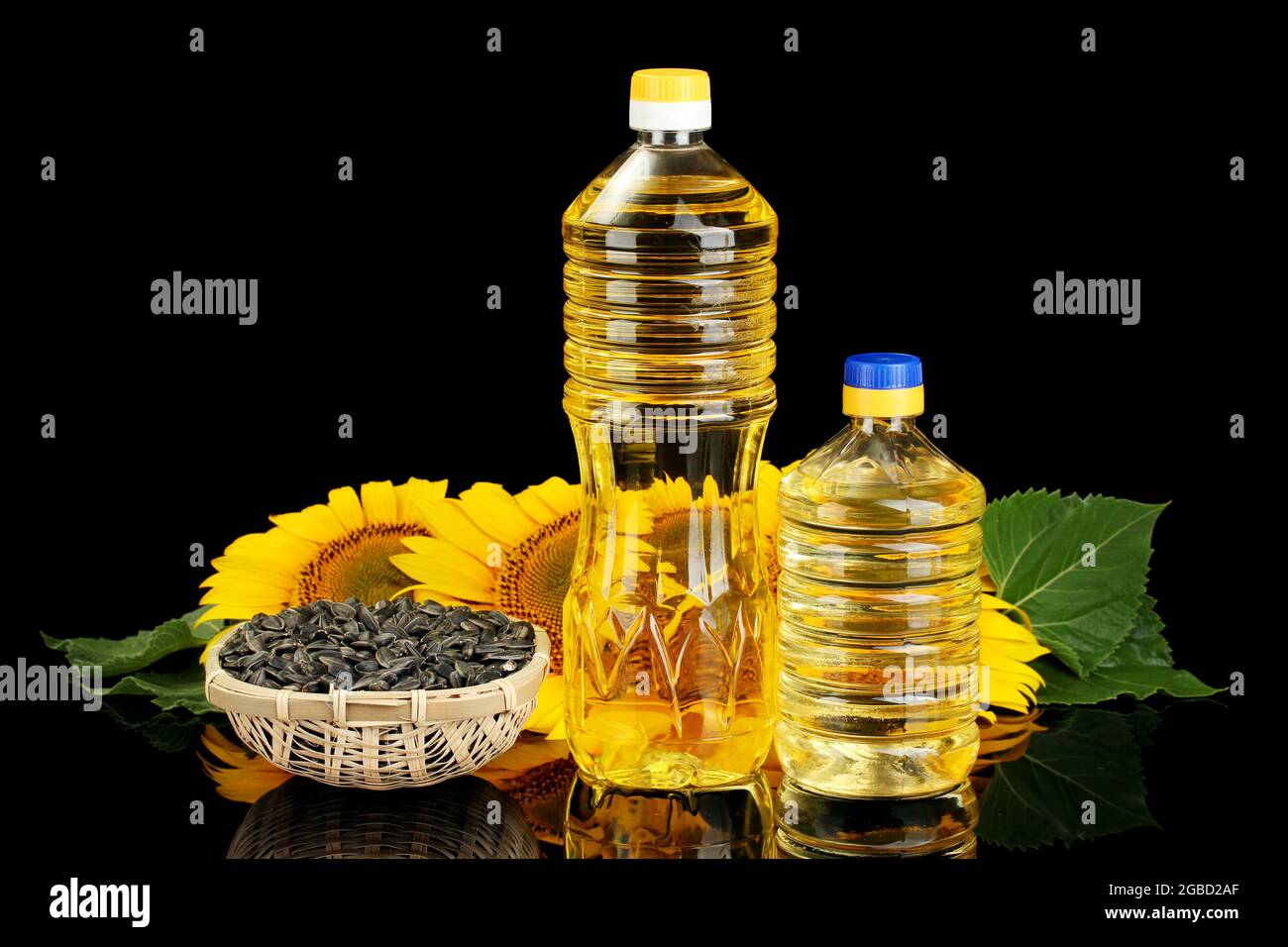 sunflower oil and sunflower isolated on black Stock Photo - Alamy