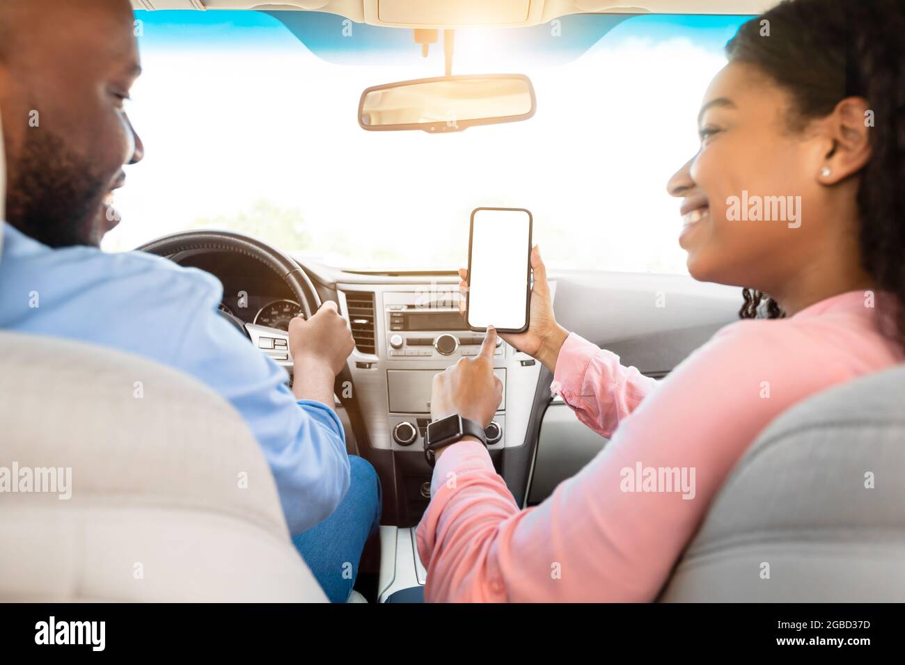 Happy African couple using showing smartphone with empty screen Stock Photo