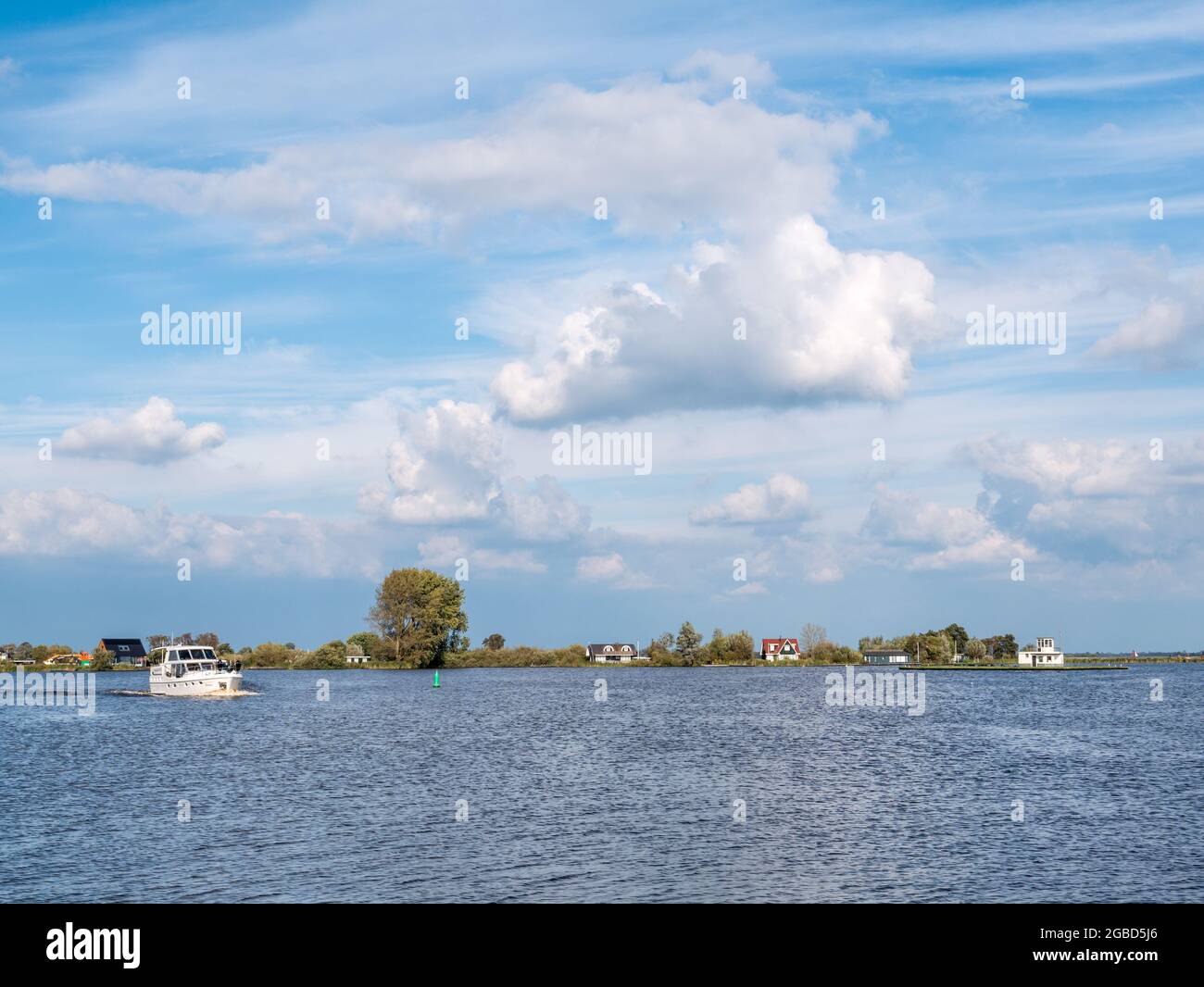 Boat cruising on Pikmeer lake in Grouw, one of Frisian lakes in Friesland, Netherlands Stock Photo