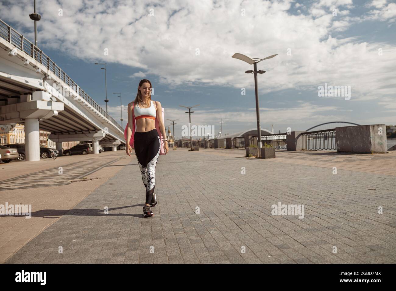Happy woman in tracksuit walks hi-res stock photography and images - Alamy