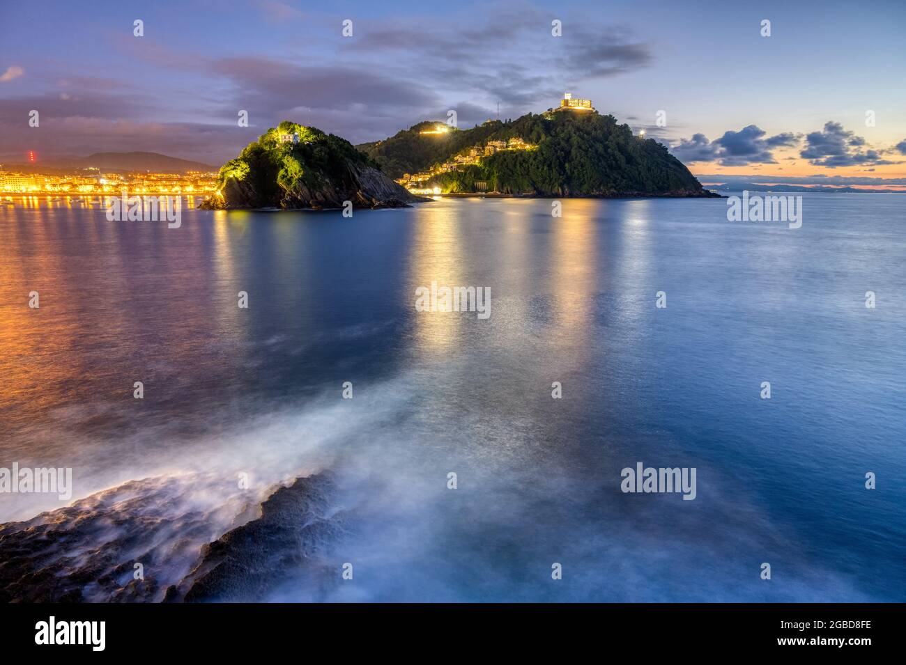 The bay of San Sebastian in Spain with Monte Igueldo after sunset Stock Photo