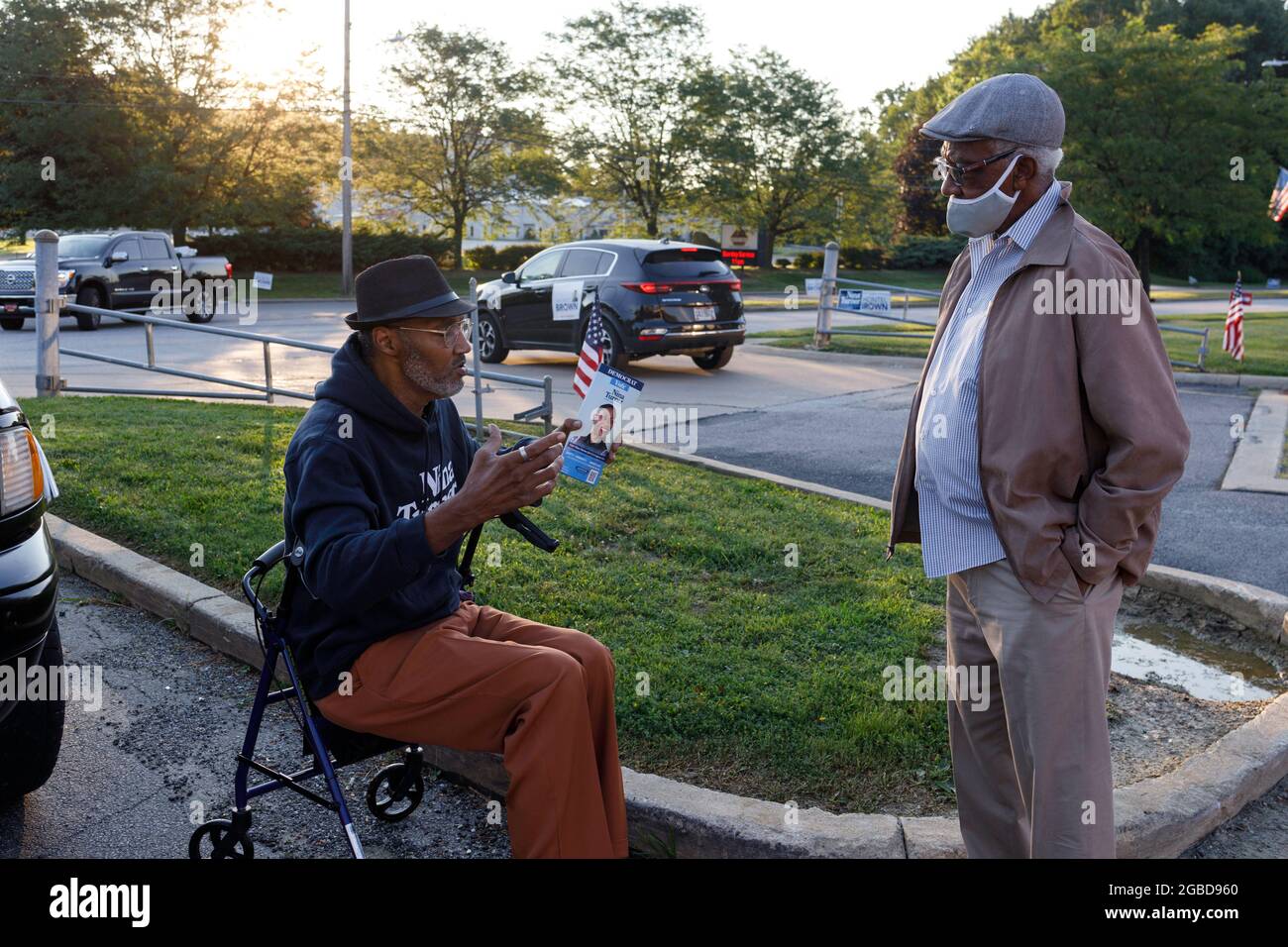 Erwin Johnson, 61, of Cleveland, Ohio talks to a voter outside of the polling place at Warrensville Heights Recreation Center. Johnson came to show support for Nina Turner because, “I think she's the best candidate. She's been a state rep, She's the most qualified.” Voters came out to the polls for a special election in Ohio's 11th district. The two main leading candidates for this House of Representatives seat are two Democrats, Nina Turner, a progressive candidate, and Shontel Brown, who represents the traditional Democratic establishment. Stock Photo