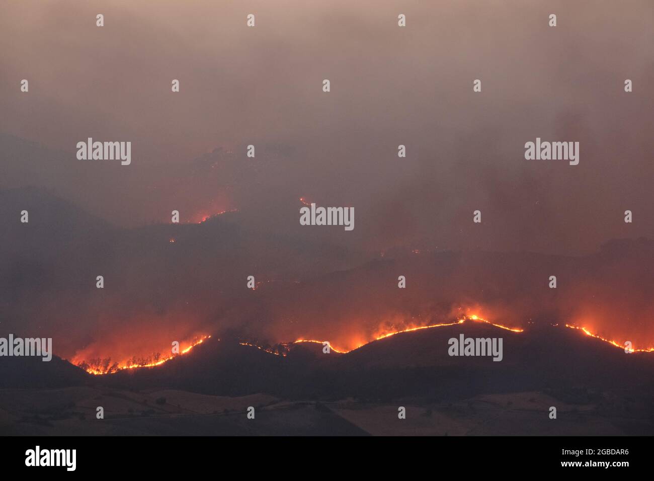 Large bushfire in the countryside of the province of Enna near the city of Aidone in Sicily on 2021 Stock Photo