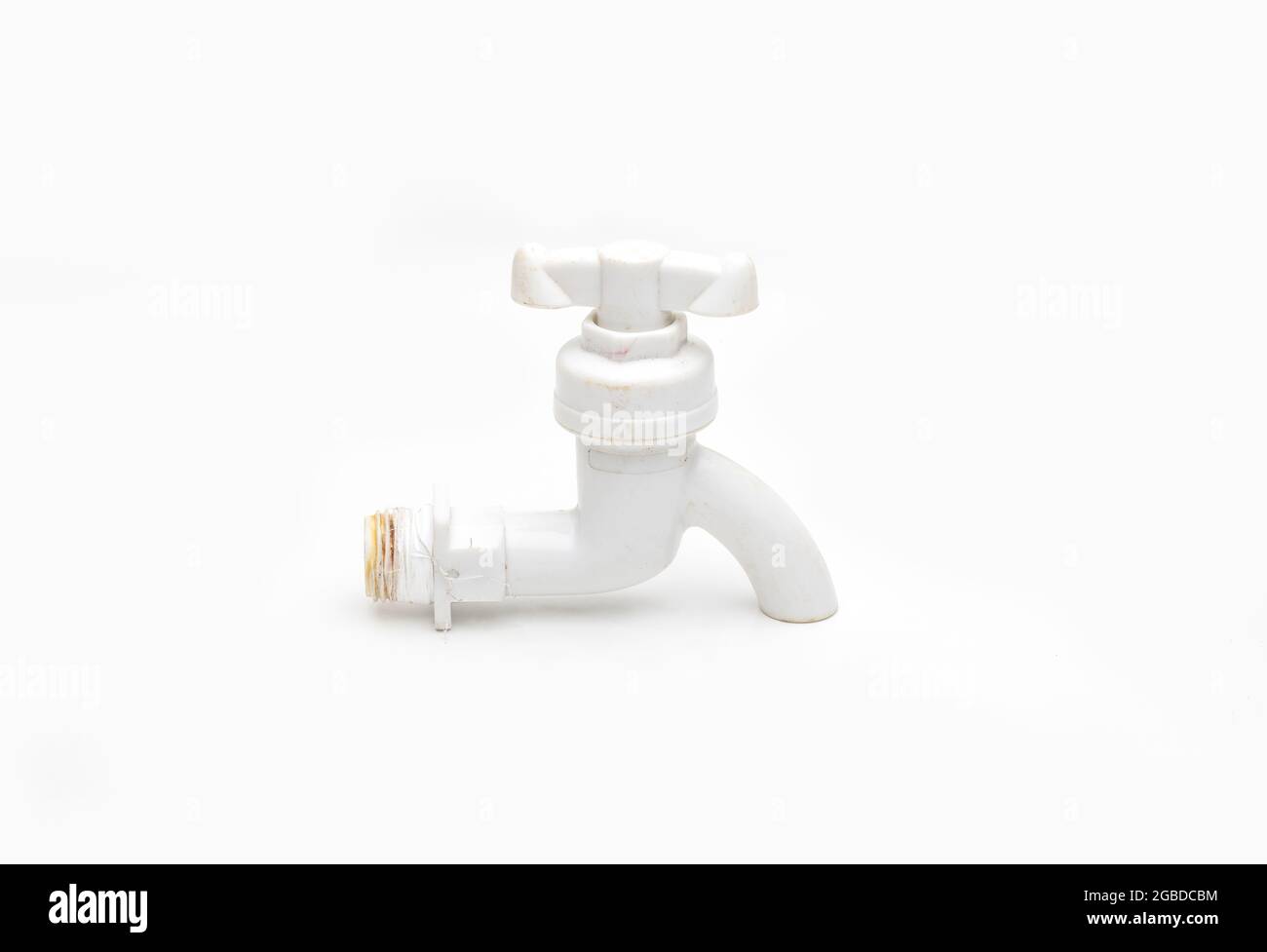 Used plumbing fitting pvc water tap close up view on isolated white