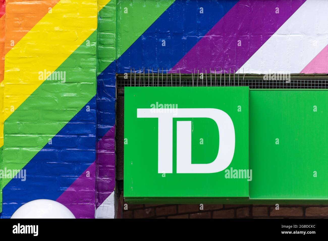 Business sign or logo of the Toronto Dominion or TD bank surrounded by Pride rainbow colors seen in the downtown district of Toronto city, Canada Stock Photo