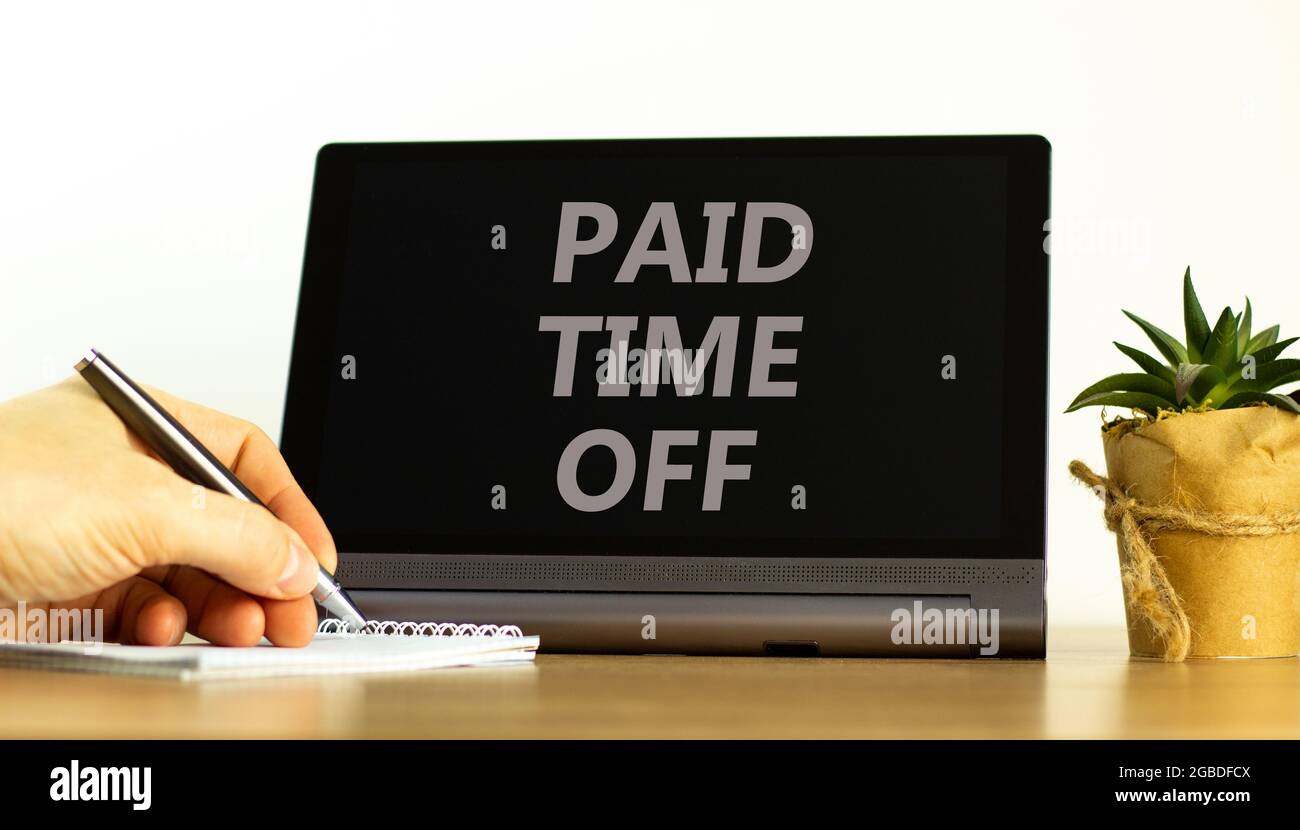 Paid time off symbol. Tablet with words 'Paid time off'. Businessman hand with pen, house plant. Beautiful white background. Business, paid time off c Stock Photo