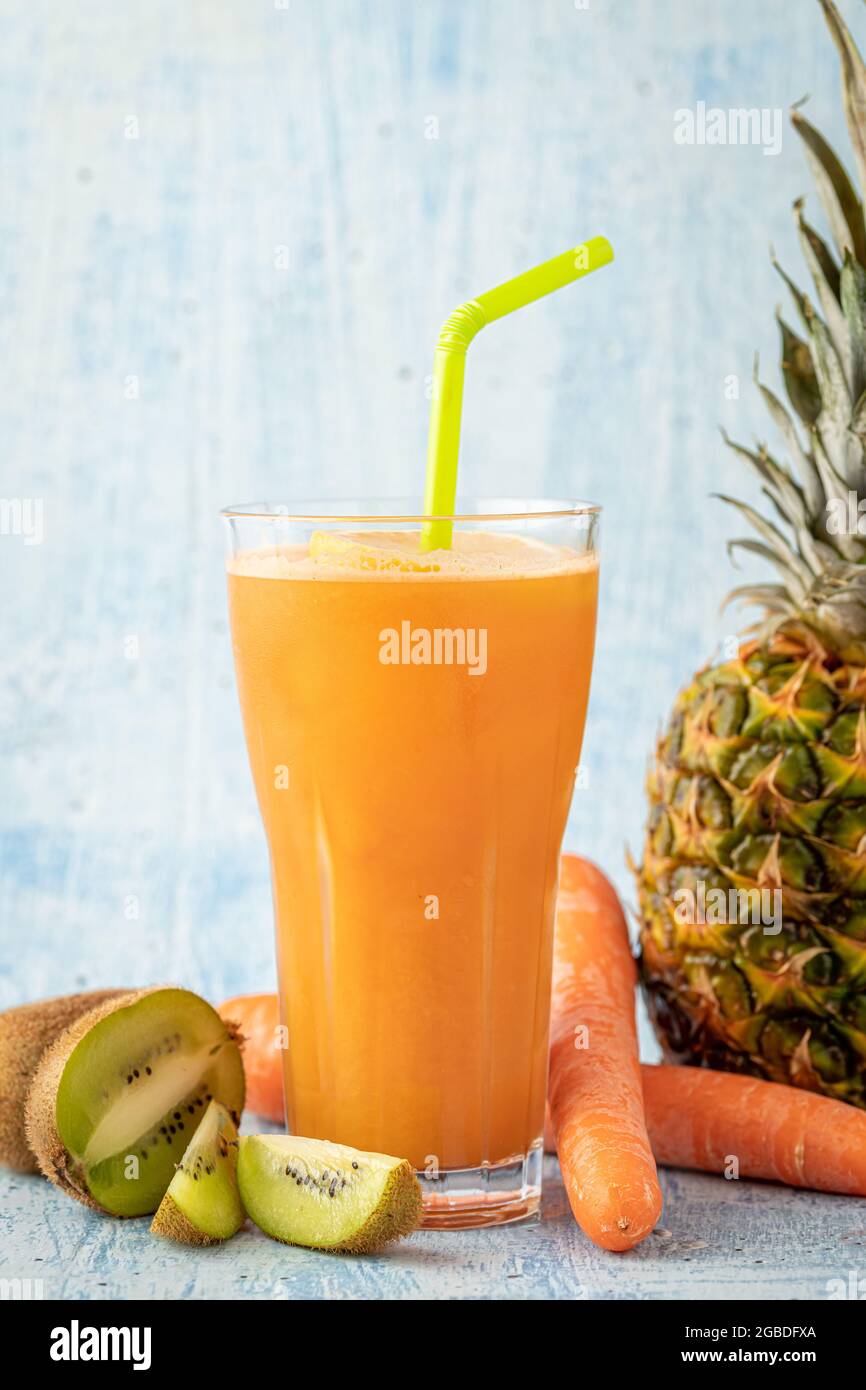 Refreshing and energizing orange juice with kiwi, pineapple and carrots Stock Photo