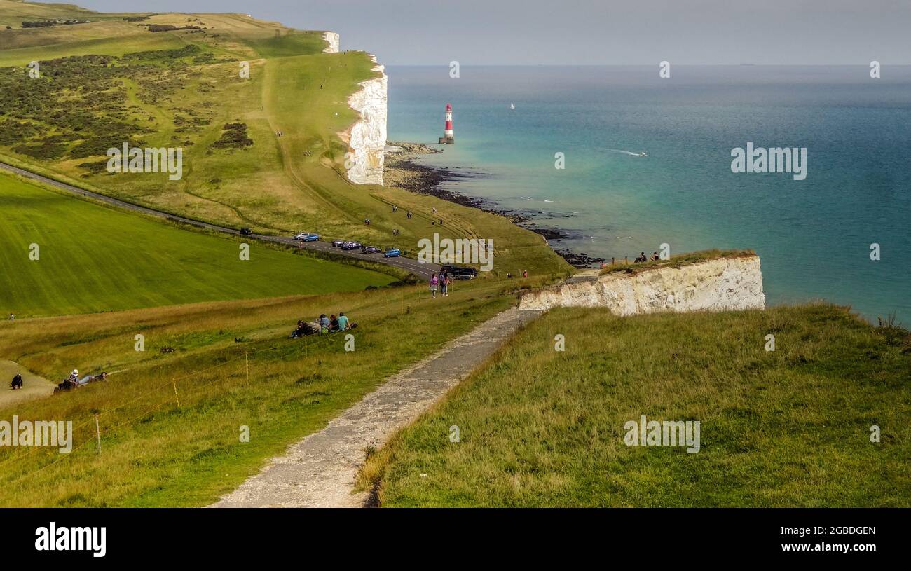 Eastbourne, East Sussex, UK. 3rd Aug, 2021. Changing scene & pristine white chalk cliff face after another large rock fall just East of the Belle Tout lighthouse, a section of the old path now relegated to the beach below. Fortunately the fall occurred in the early hours of Friday morning so no persons were present near the edge. More falls are imminent as the sedimentary rock has been softened by heavy rain & further fissures are evident. Credit: David Burr/Alamy Live News Stock Photo