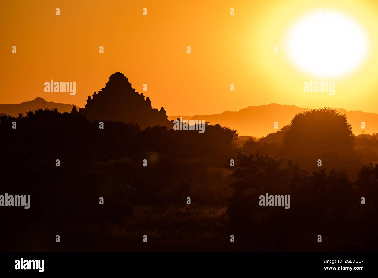 The sunset behind a mighty temple in the World Heritage Site of Bagan in Myanmar Stock Photo