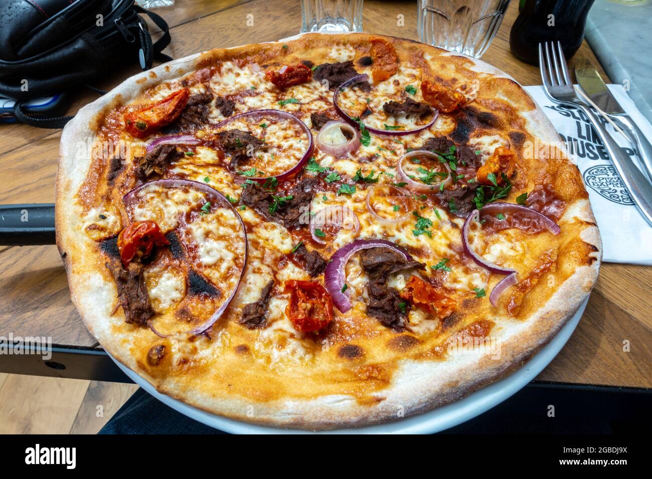 An Italian thin crust pizza at a Pizza Express restaurant. Stock Photo
