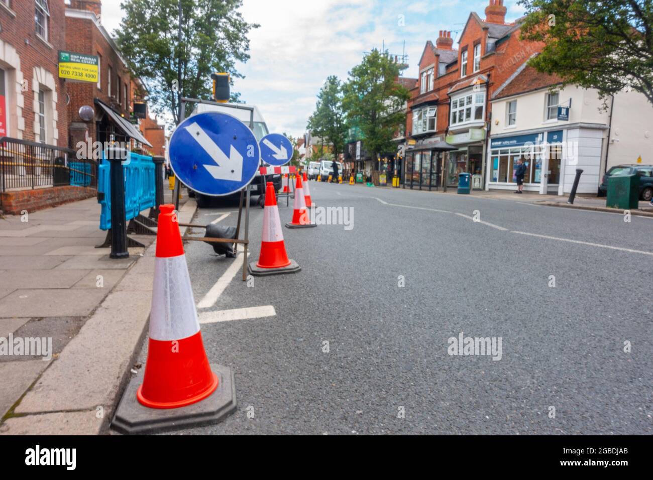 Roadworks on Broad Street in Wokingham, UK with cones lining the side of the road. Stock Photo