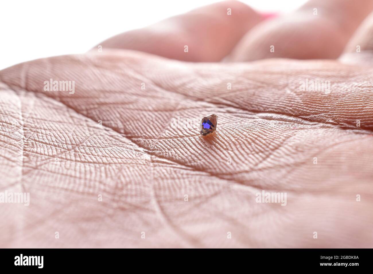 Diamond In Hand Palm, Macro Image Of Diamond in Hand Stock Photo