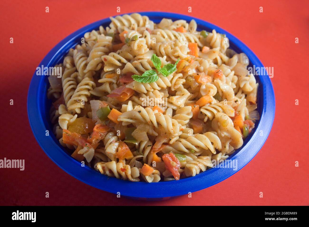 Bowl full of fresh homemade elbow macaroni pasta with sausage pieces