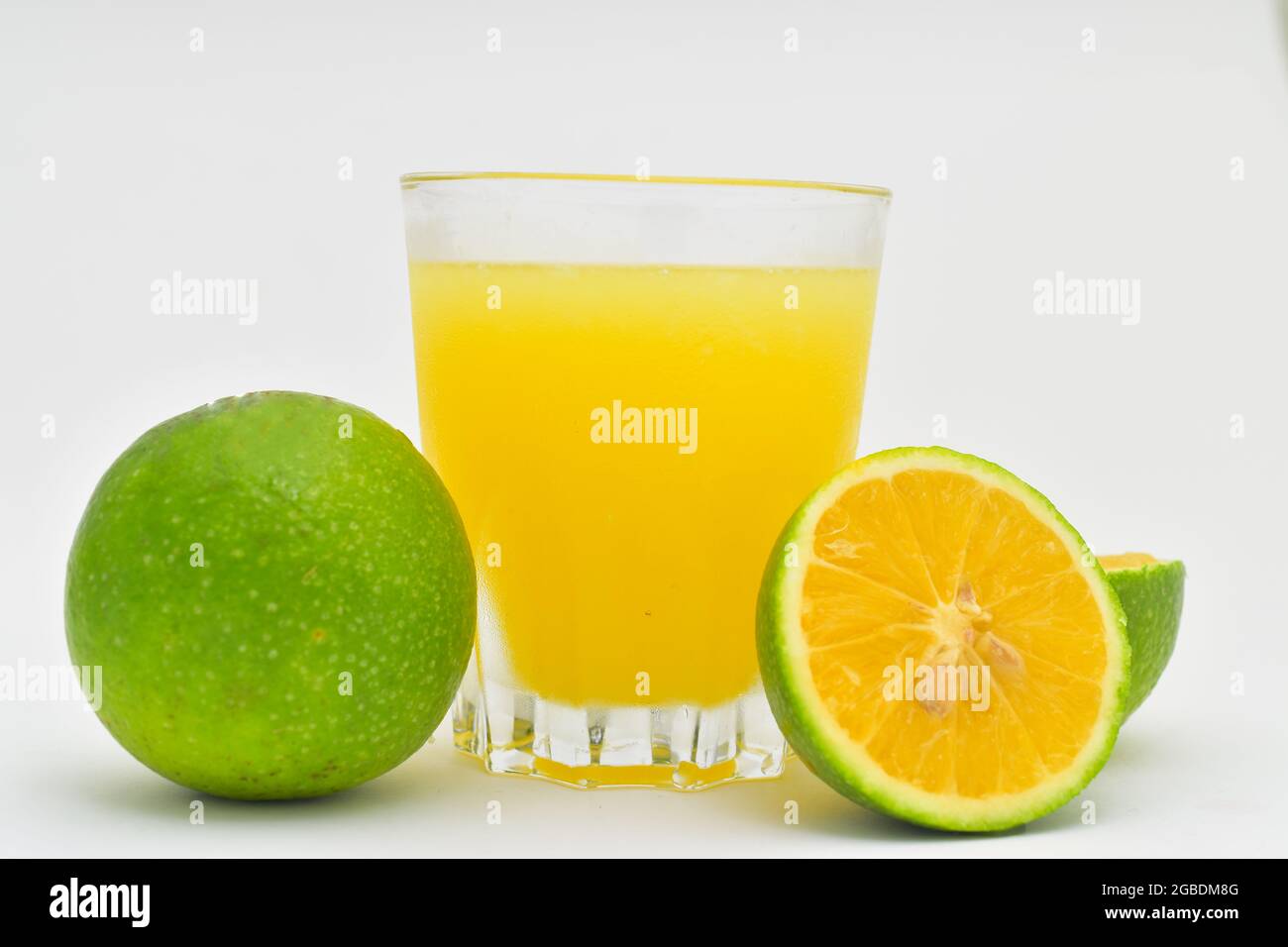 Lemonade or lemon juice and cut fresh lemons isolated on white background, Mosambi juice Stock Photo