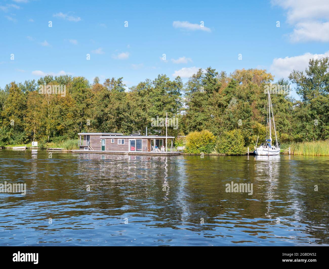 Houseboat and sailboat in canal Wide Ie in national park Alde Feanen, Friesland, Netherlands Stock Photo