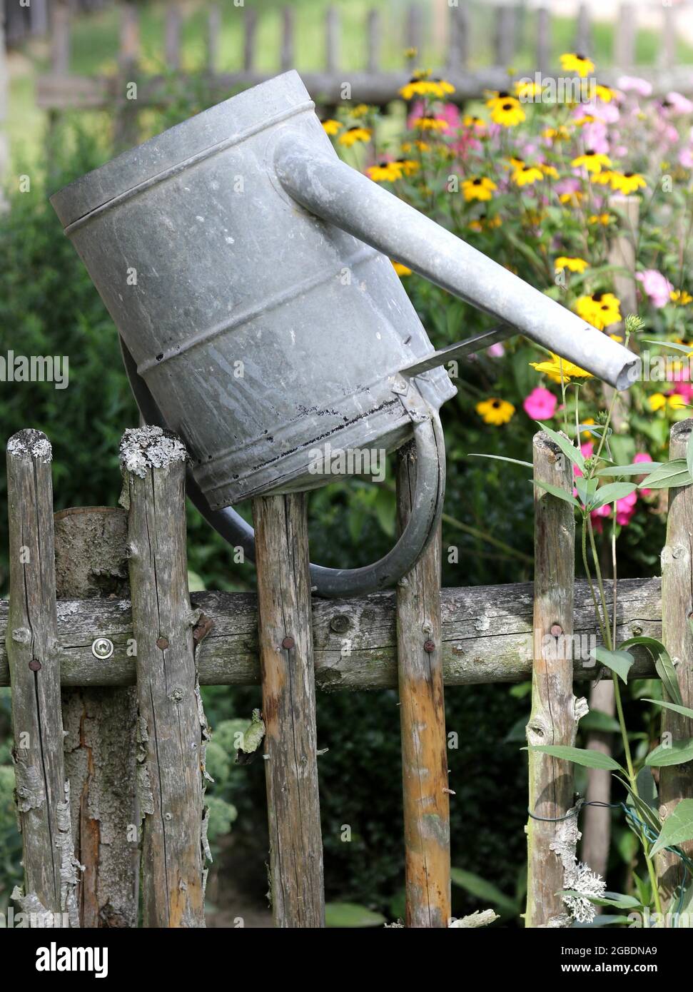 Bucket upside down on a fence Stock Photo