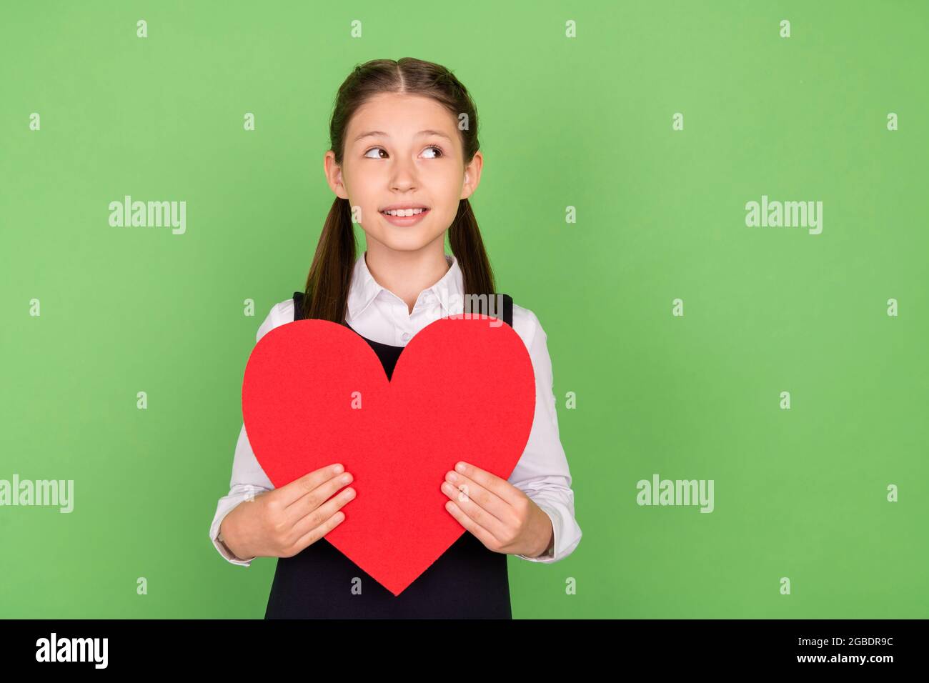 Photo of young school girl happy positive smile hold big red paper ...