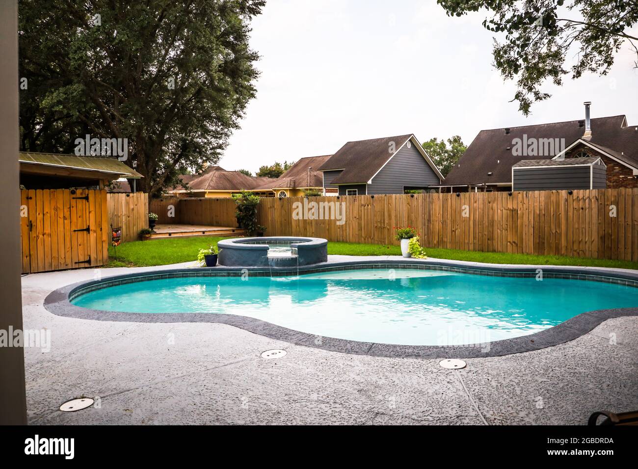 A large free form gray grey accent swimming pool with turquoise blue ...