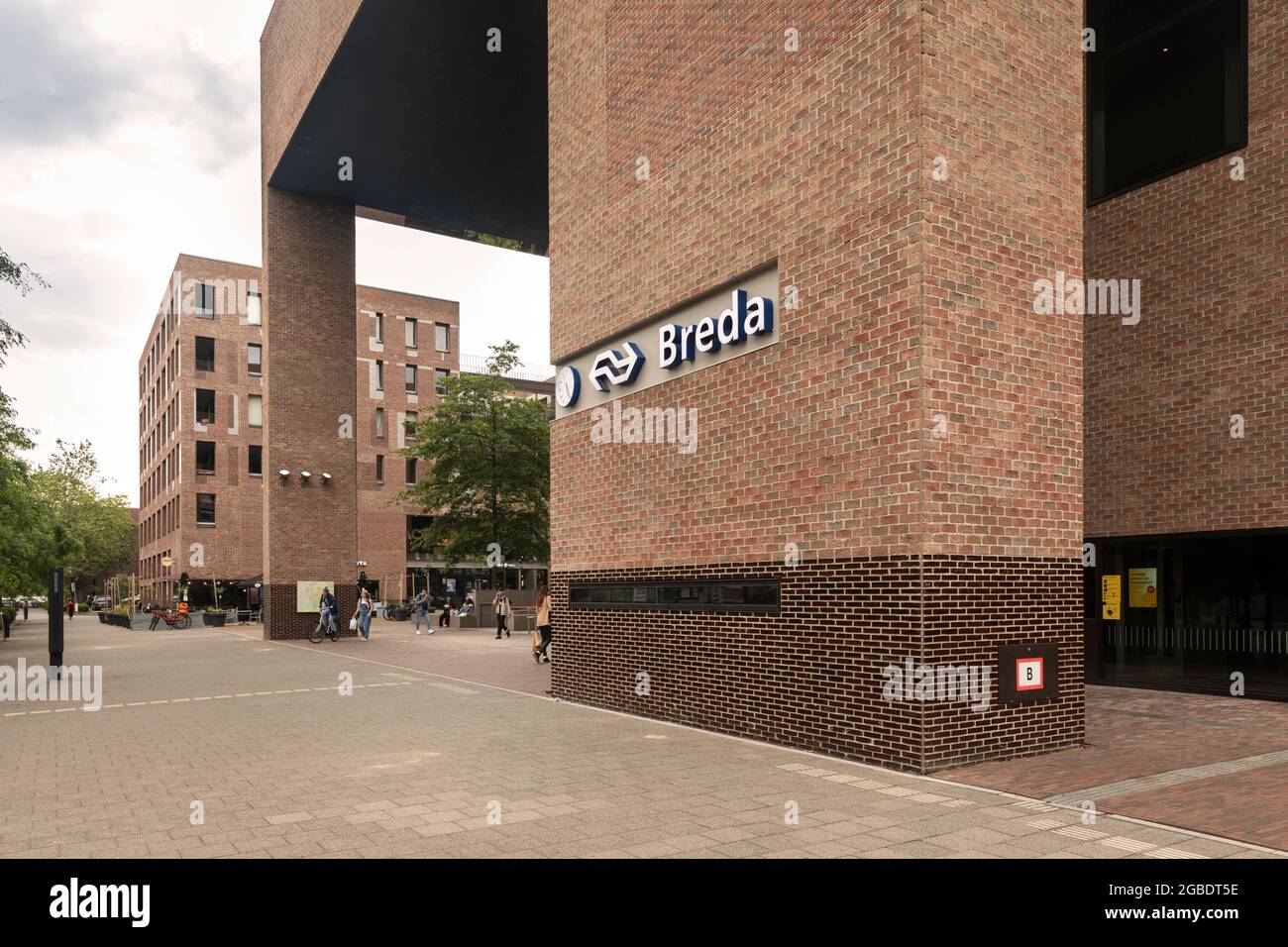 Breda, The Netherlands June 28th 2021. The central station of Breda, a dutch city in North Brabant, with the logo of NS and a clock on the brick wall Stock Photo