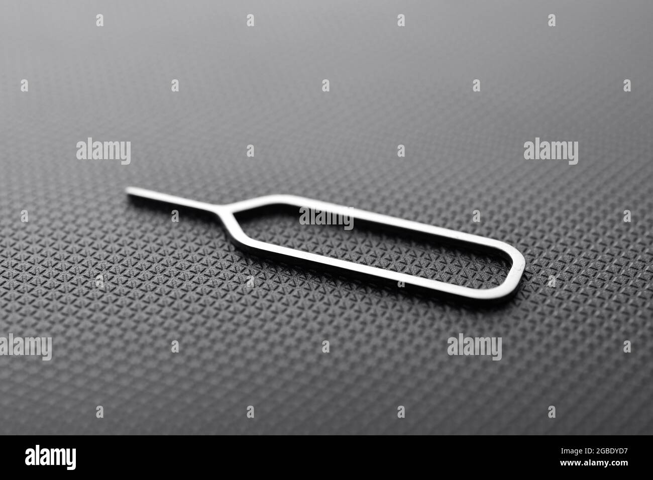 Sim Ejector Tool On Black Textured Background Stock Photo