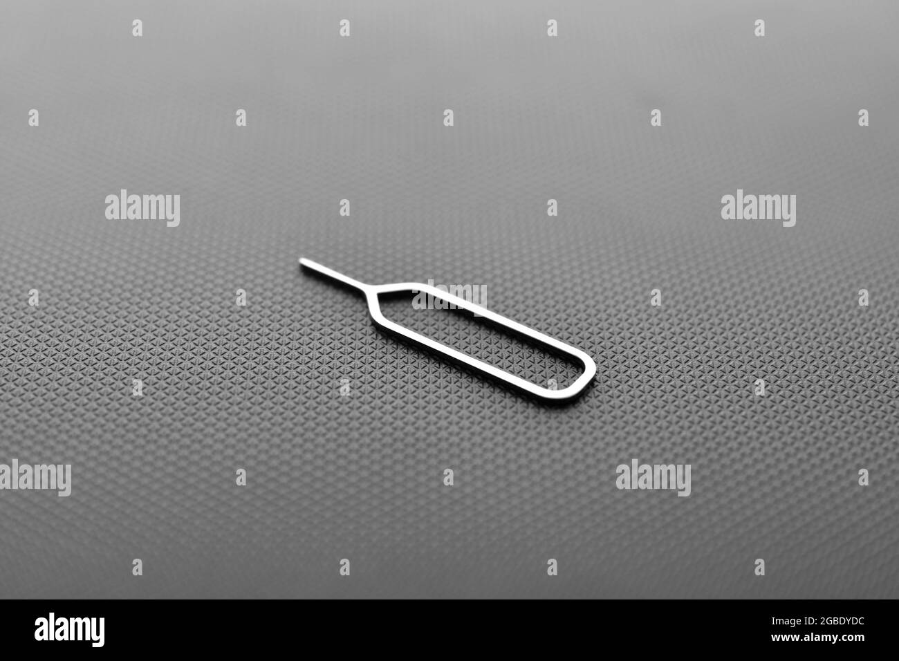 sim card ejector tool on black texture background Stock Photo Alamy