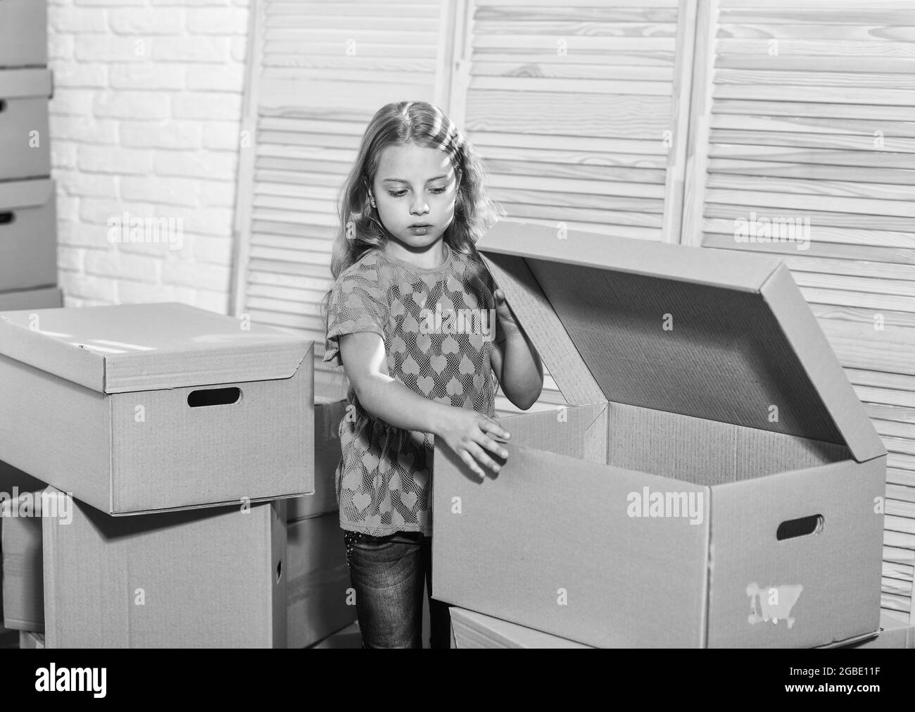 Cardboard boxes moving to new house. happy child cardboard box