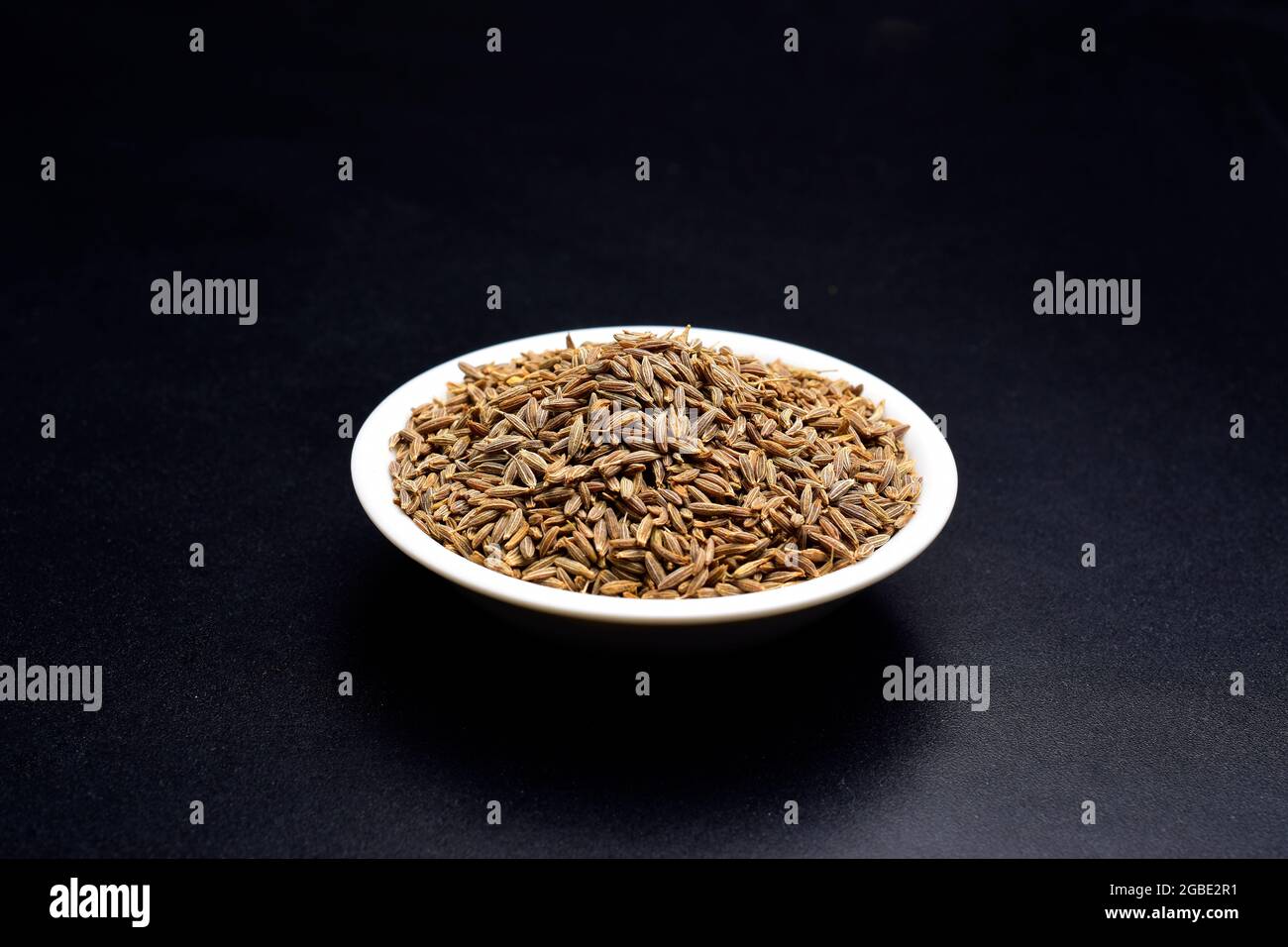 cumin seeds (jeera) in ceramic bowl on black background Stock Photo Alamy