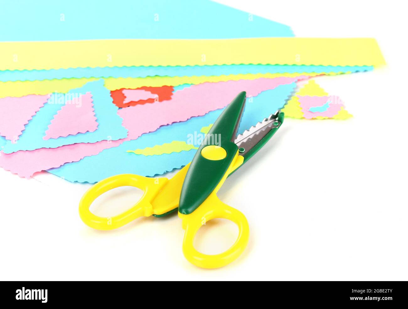 Colorful zigzag scissors with color paper isolated on white Stock Photo