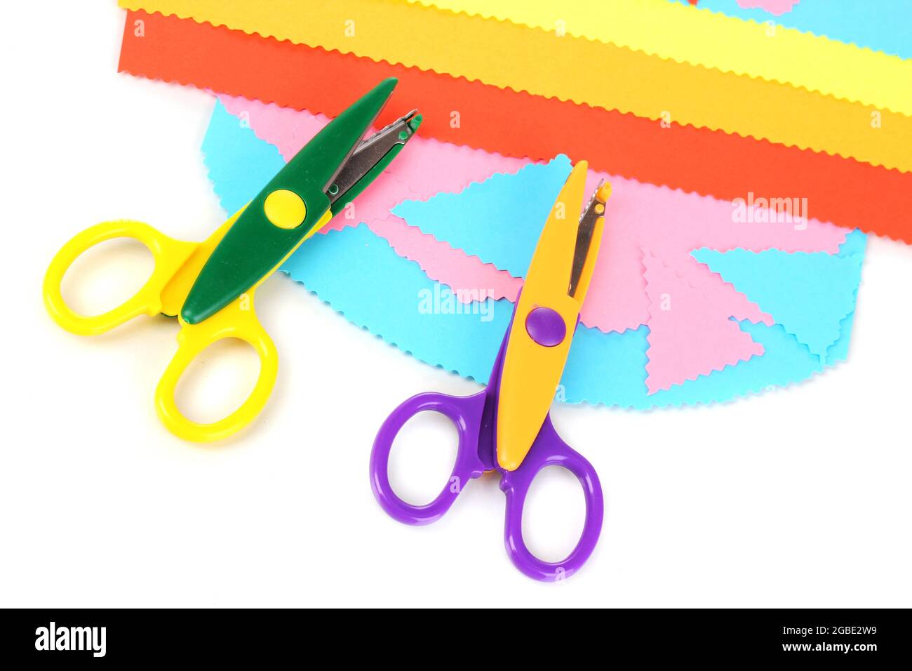 Colorful zigzag scissors with color paper isolated on white Stock Photo