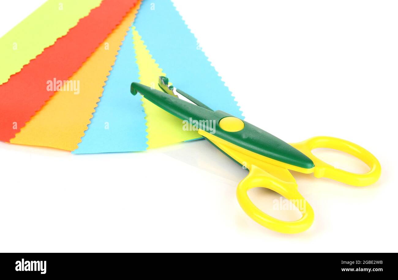 Colorful zigzag scissors with color paper isolated on white Stock Photo