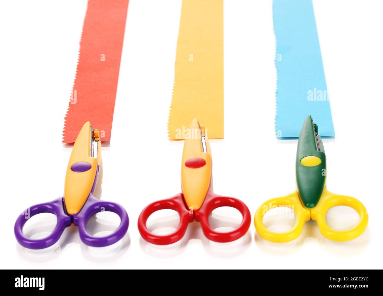 Colorful zigzag scissors with paper strips isolated on white Stock