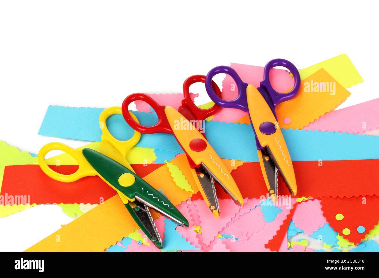 Colorful zigzag scissors with color paper isolated on white Stock Photo