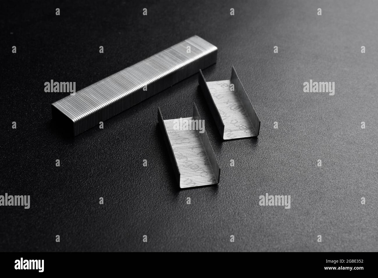 Stapler Pin On Dark Background Stock Photo