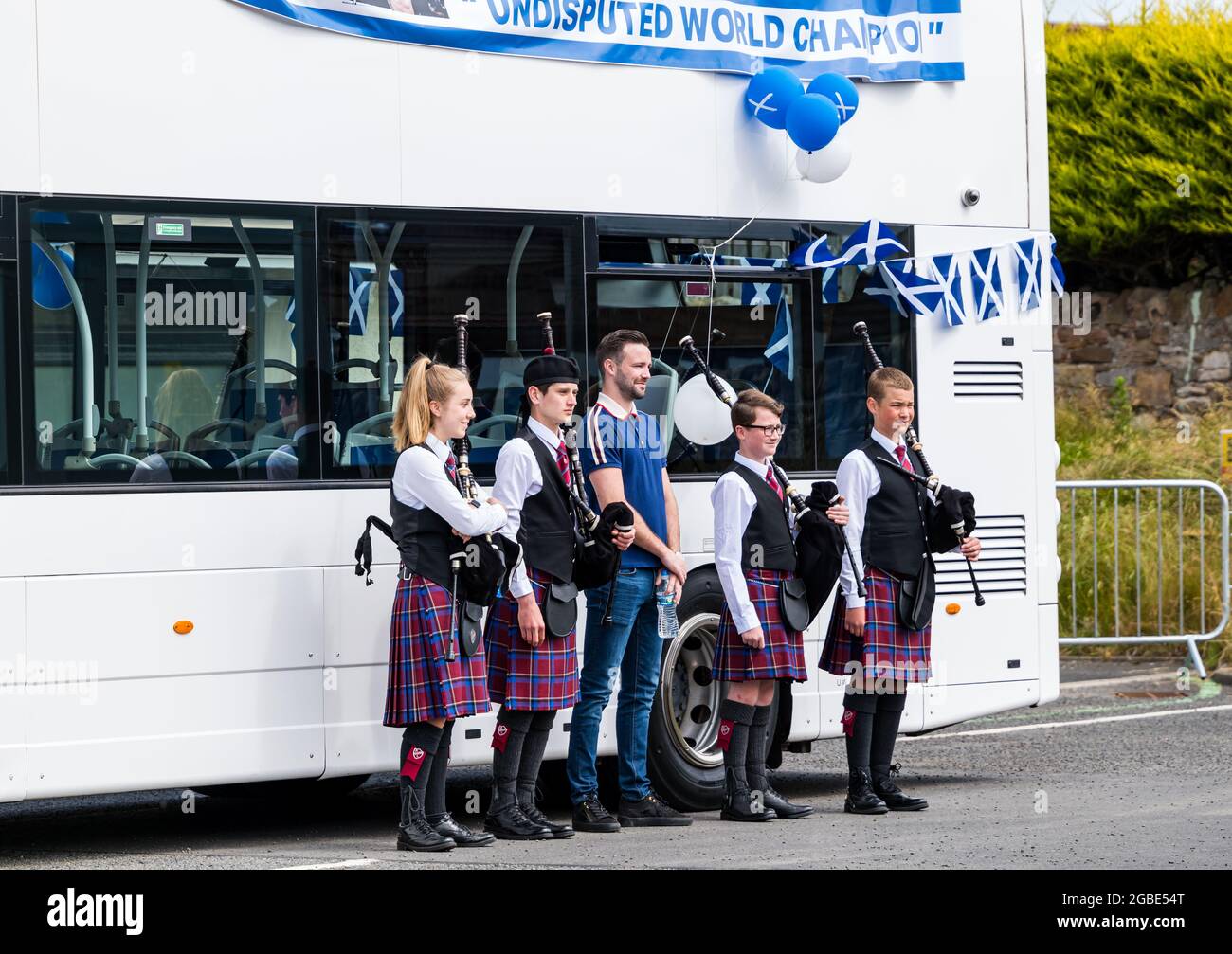 World boxing champion Josh Taylor with children pipers at victory bus tour, Prestonpans, East Lothian, Stock Photo Alamy