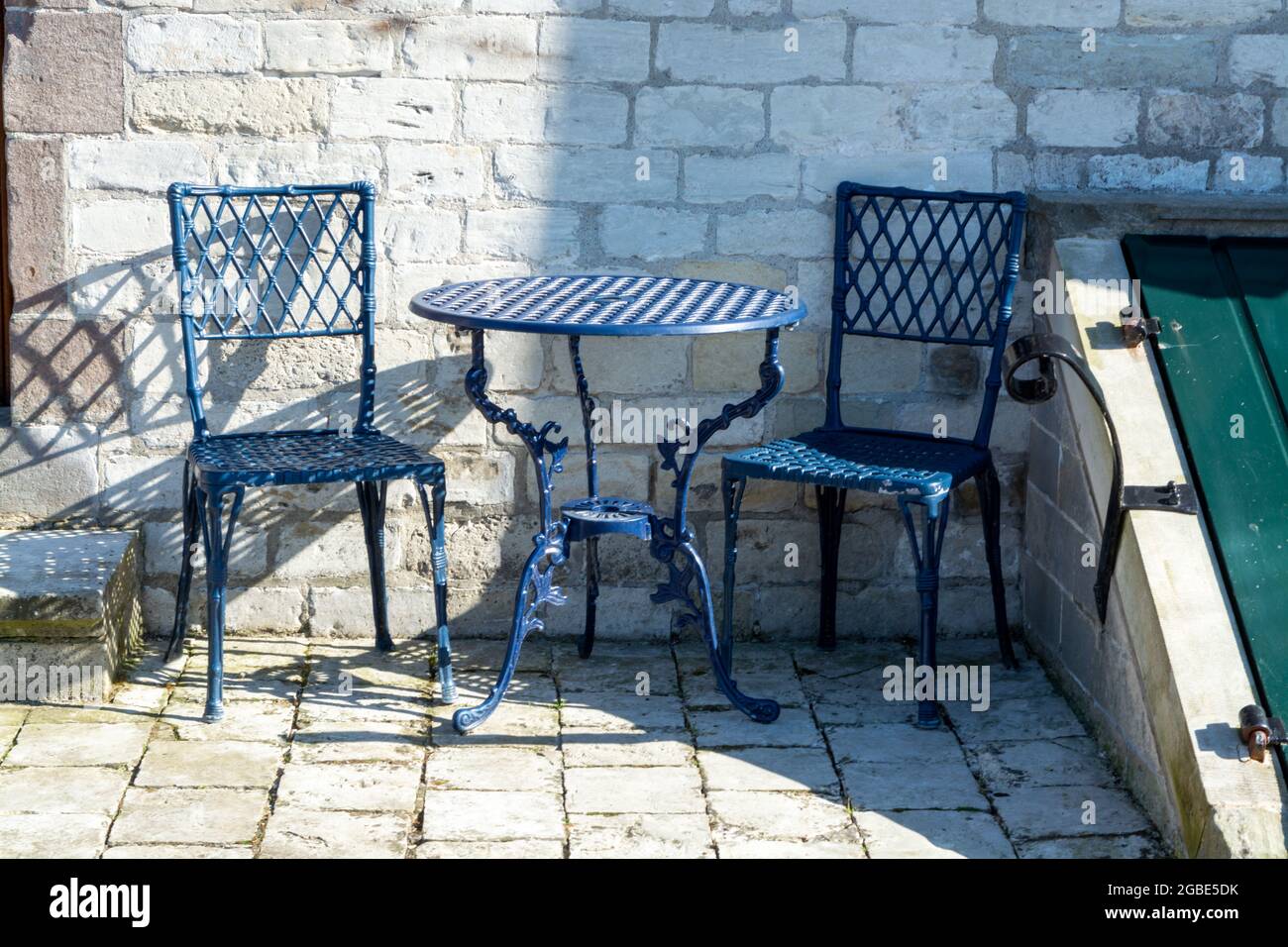 Vintage metal bistro table and chairs set in outdoor cafe, used for