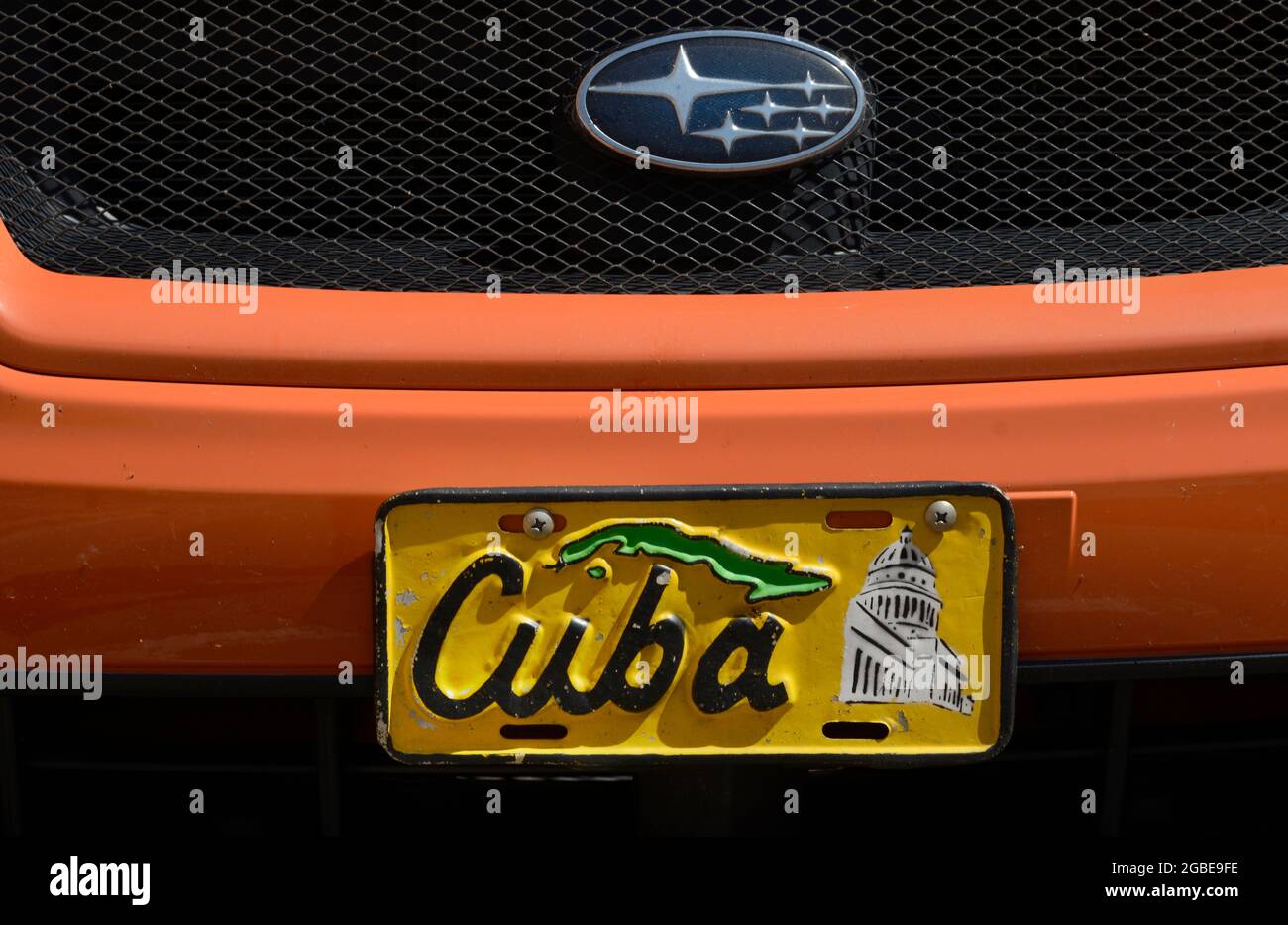 A vintage decorative front license plate from Cuba on an American car