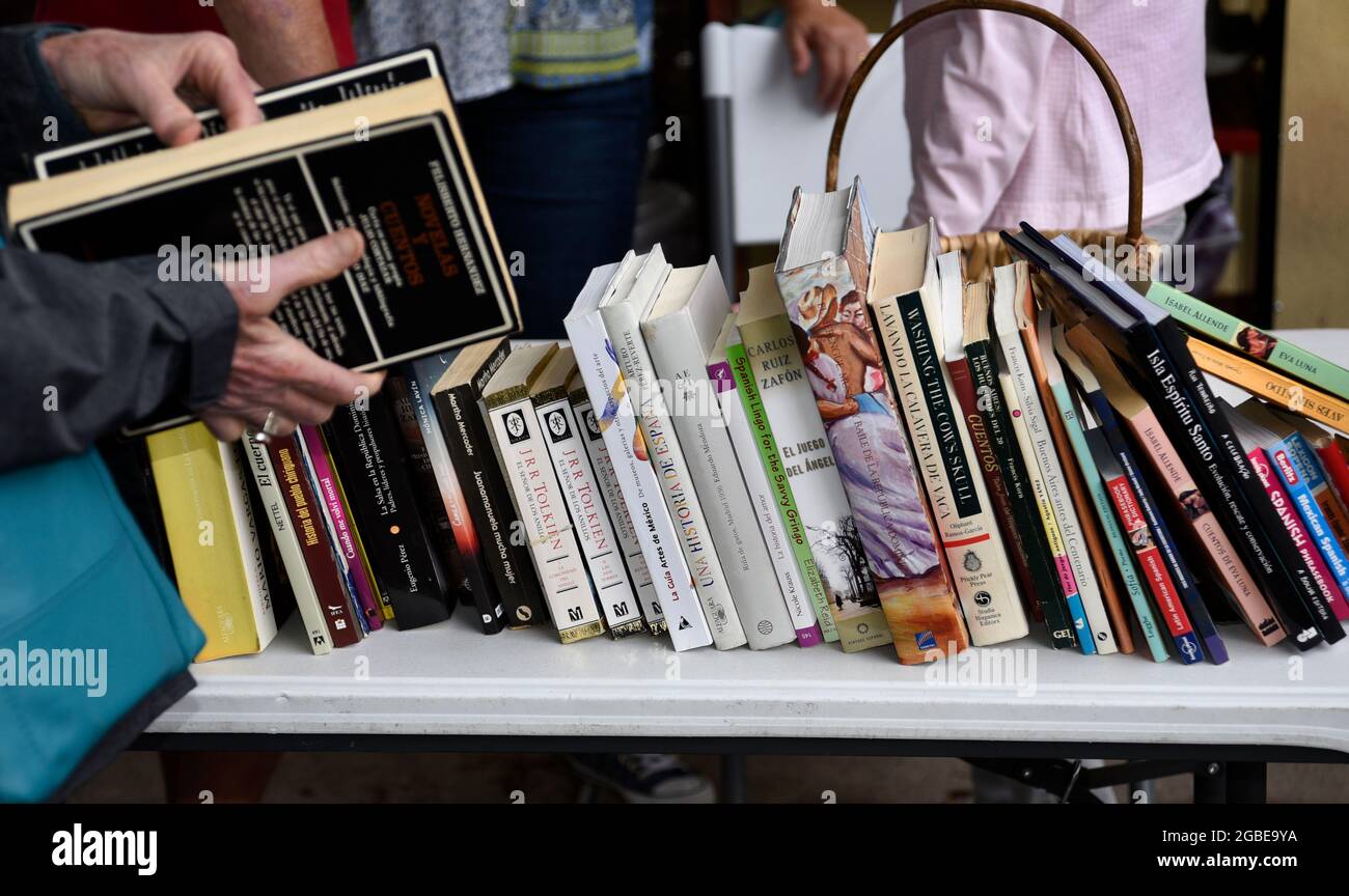 Volunteers a a public library oversee asidewalk sale of duplicate and other unwanted library books in Santa Fe, New Mexico. Stock Photo