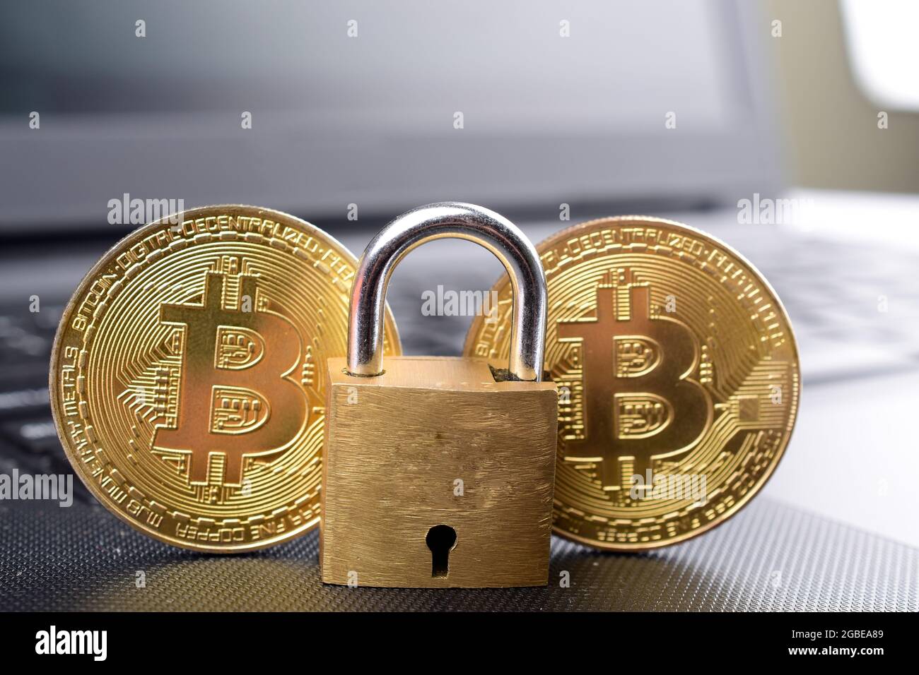 bitcoin security concept. Gold coin with padlock on laptop Stock Photo ...