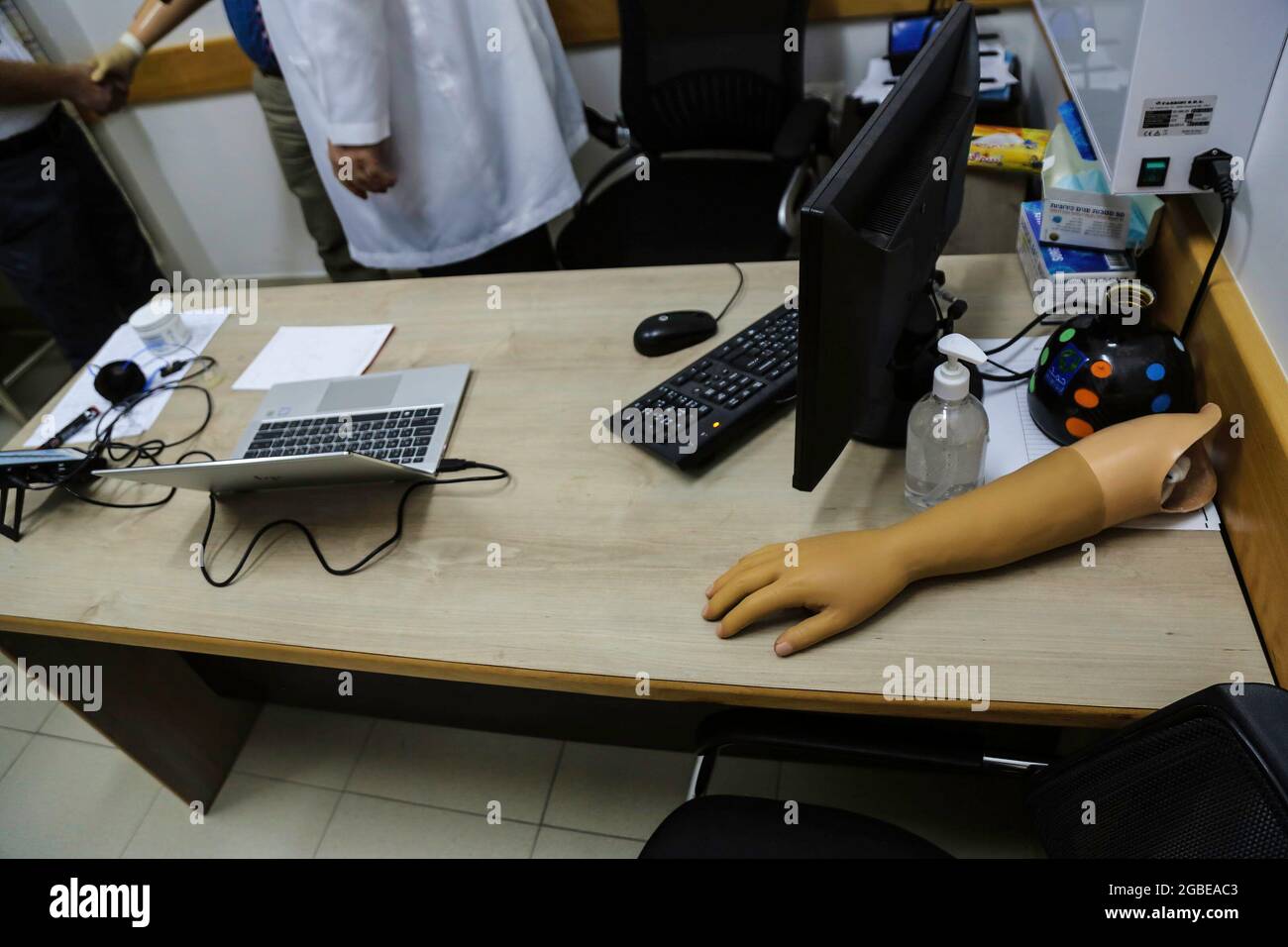 Gaza, Palestine. 03rd Aug, 2021. A prosthetic hand is seen on a doctor's table in the HH Sheikh Hamad Hospital for Rehabilitation and Prosthetics in Gaza. Gaza strip has witnessed the first installation of a smart prosthetic hand for a Palestinian amputee man as a test at HH Sheikh Hamad Hospital for Rehabilitation and Prosthetics, funded by the Qatar Fund For Development (QFFD) as part of the Qatari support to the Palestinian Health sector. Credit: SOPA Images Limited/Alamy Live News Stock Photo