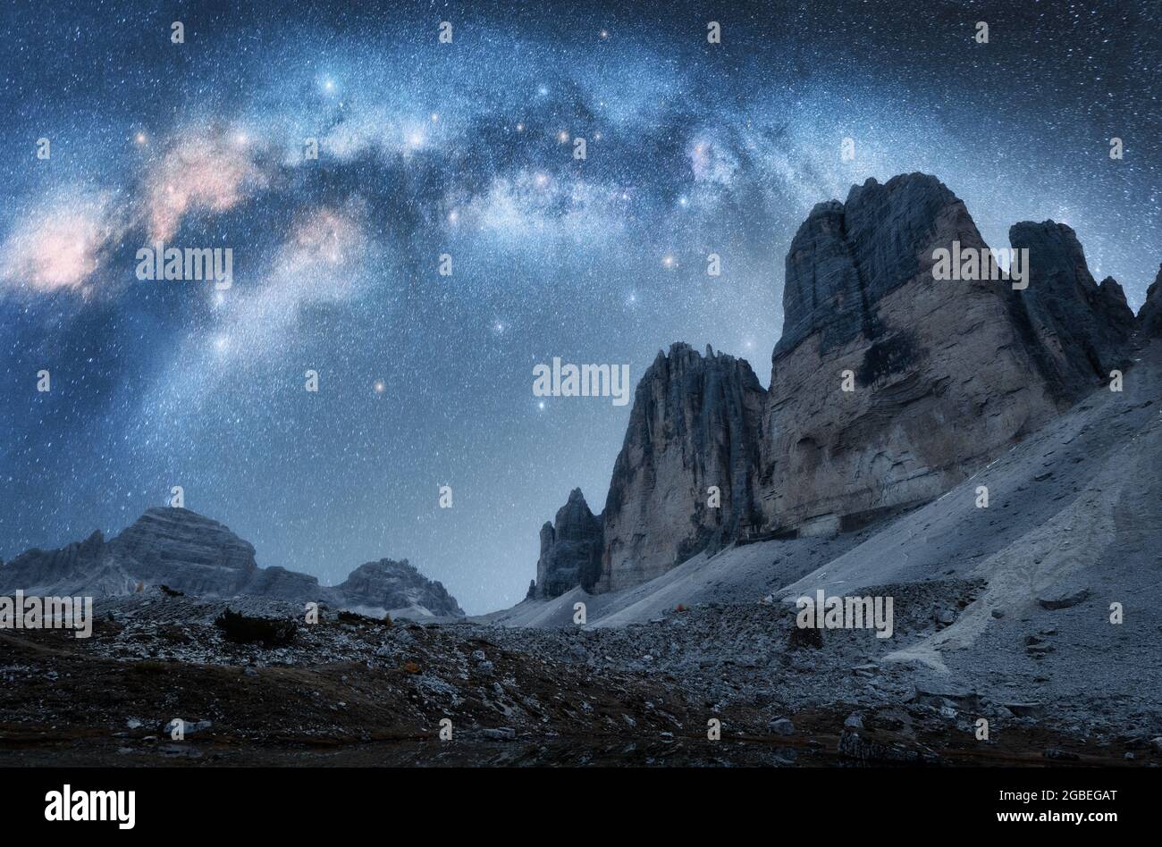 Milky Way arch and mountain peaks at night in summer Stock Photo