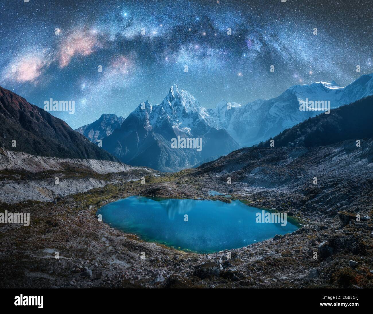 Milky Way over snowy mountains and lake at night. Landscape Stock Photo ...
